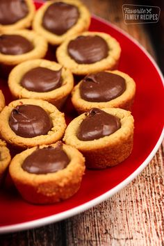 chocolate covered cookies are on a red plate