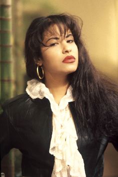 a woman with long hair wearing a black jacket