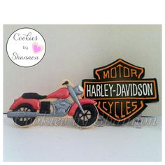 a cake shaped like a motorcycle with the words harley davidson cycles on it's side