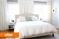 a white bed sitting in a bedroom on top of a hard wood floor next to two windows