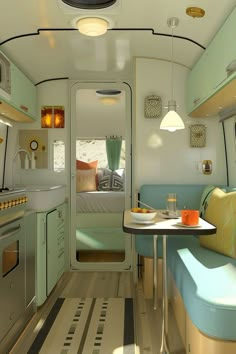 an interior view of a small kitchen and living area in a bus or van with the door open