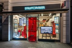 the entrance to a store with red doors