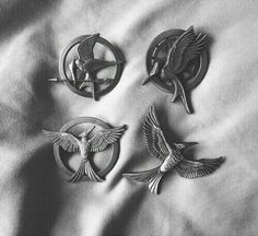 three metal birds on a white sheet with black and white image in the back ground