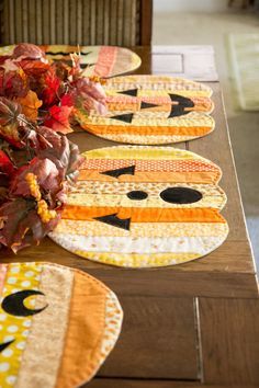 the table is set with placemats made to look like cats and pumpkins