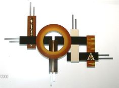 an abstract sculpture with wood and metal pieces on it's sides, including a circle