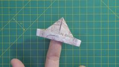 a hand is pointing at a paper airplane