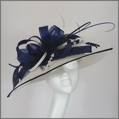 Stunning sinamay hat for weddings and race days. Made in white and navy blue. Decorated with large crinoline and sinamay loops, curled ostrich quills and delicate feathers.  Designs can be made to order in a range of different colours or styles, see our colour chart: https://jacquivaledesigns.co.uk/pages/sinamay-colour-chart Please contact me if you would like a design in a different colour. We can make a range of womens hats, fascinators and accessories for any type formal event. Such as weddin Navy Formal Hat With Curved Brim, Navy Curved Brim Formal Hat, Elegant Navy Wide Brim Hat, Elegant Navy Hats With Curved Brim, Elegant Navy Hat With Curved Brim, Royal Blue Wedding Hat With Curved Brim, Mother Of The Bride Hats, Sinamay Hat, Womens Hats