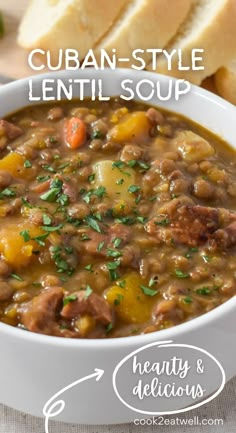 a white bowl filled with soup next to bread