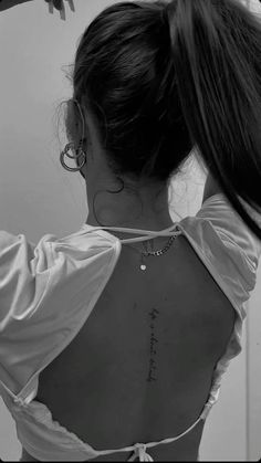 the back of a woman's neck with writing on it