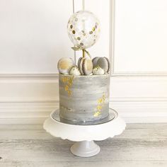 a cake decorated with gold and silver decorations