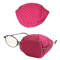 a pair of glasses sitting on top of a pink polka dot bag