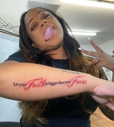 a woman with a tattoo on her arm saying let your faith bigger than yours