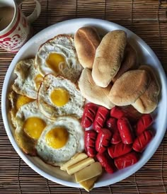 a plate with eggs, sausages and bread on it