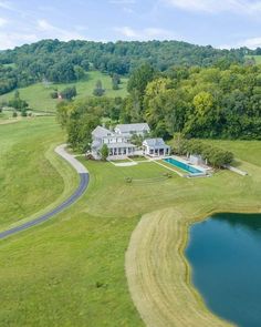 an aerial view of a large house with a swimming pool in the middle of it