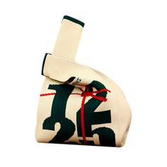 a white and green bag with a red ribbon on it's end that has the number twenty five printed on it