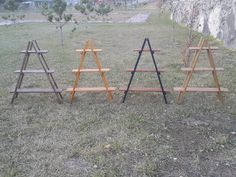 three wooden shelves sitting on top of a grass covered field