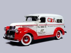 an old fashioned red and white truck on a gray background with the words nenk written on it