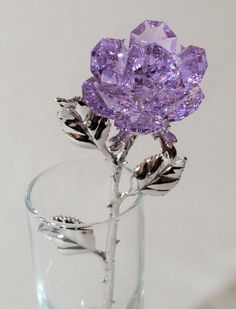 "This exquisite rose is manufactured by Bjcrystals in the United States using genuine Swarovski crystal. The purple colored crystal rose comes to life as light causes the crystal to sparkle. The rose is approximately 5\" long and the rose bud is approximately 1 1/2\" in diameter. The rose sits in a glass vase that is approximately 4\" tall and is filled with sparkling Swarovski crystals that enhance the beauty of the rose. The item comes packaged in a gift box. The stem is a silver tone color." Crystal Purple, Purple Rose, Purple Flower, Pink Flower, Clear Glass, Swarovski Crystals, Seasonal Decor, Vase, Crystals