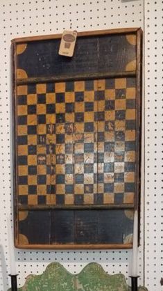 an old chess board hanging on the wall