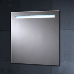 a bathroom mirror with lights on it and a wall mounted light above the mirror in front of it