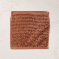 a brown bath mat sitting on top of a white counter