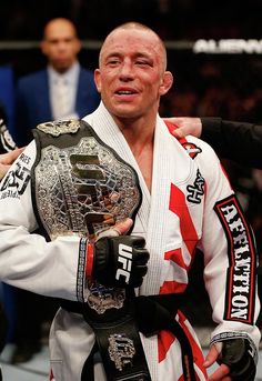 a man holding a wrestling belt in his hands