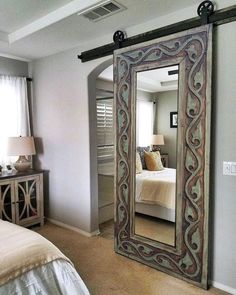 a bedroom with a large mirror on the wall