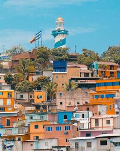 the colorful houses are on top of each other in this cityscape with a light tower