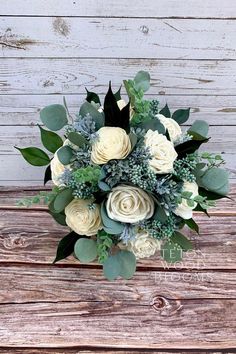 a bouquet of flowers sitting on top of a wooden table