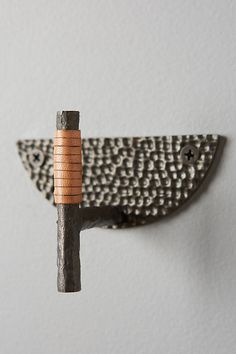 an iron and wood object hanging on the wall