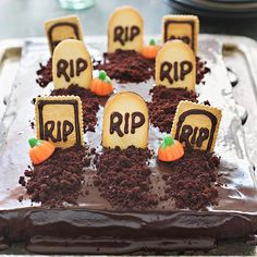 a cake decorated to look like tombstones with carved pumpkins and graves on them