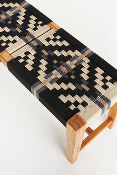 a wooden bench made out of woven material