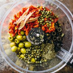 a food processor filled with olives and seasonings