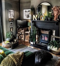 a living room filled with furniture and a fire place next to a mirror on the wall