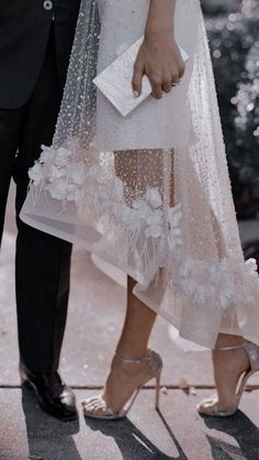 a bride and groom standing next to each other