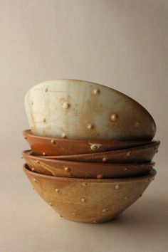 a stack of ceramic bowls sitting on top of each other