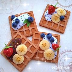 three waffles decorated with fruit and chocolate