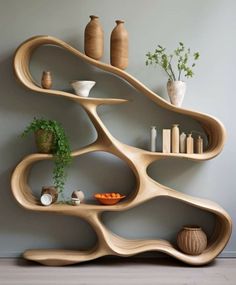 the shelves are made out of wood and have vases on each shelf with plants in them