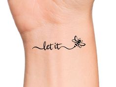 a woman's wrist tattoo with the word let it fly on her left arm