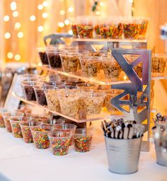 an assortment of desserts are displayed on a buffet table at a wedding or party