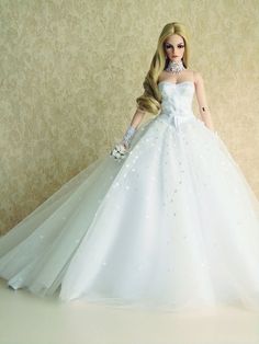 a barbie doll wearing a white wedding dress with long blonde hair and gloves on her head