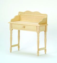 a small wooden desk with a drawer on the top and legs at the bottom, against a white background