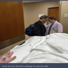 two doctors are looking at an unmade bed