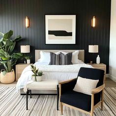 a bedroom with black walls and white bedding