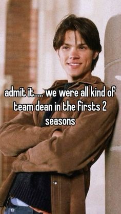 a man leaning against a wall with his arms crossed and the words admit it we were all kind of team dean in the first 2 seasons