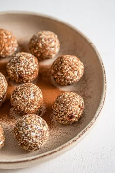 a plate filled with chocolate truffles on top of a table