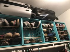 a closet filled with lots of different types of shoes and luggage on top of it