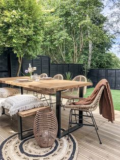 an outdoor table and chairs on a deck