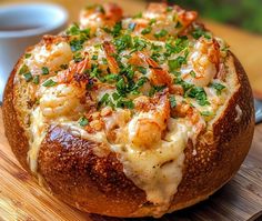 a bread bowl filled with shrimp and cheese