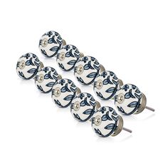 six blue and white knobs with leaves on them